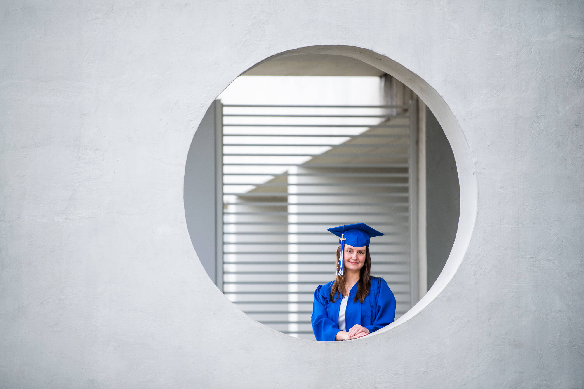 Student standing in cap and gown